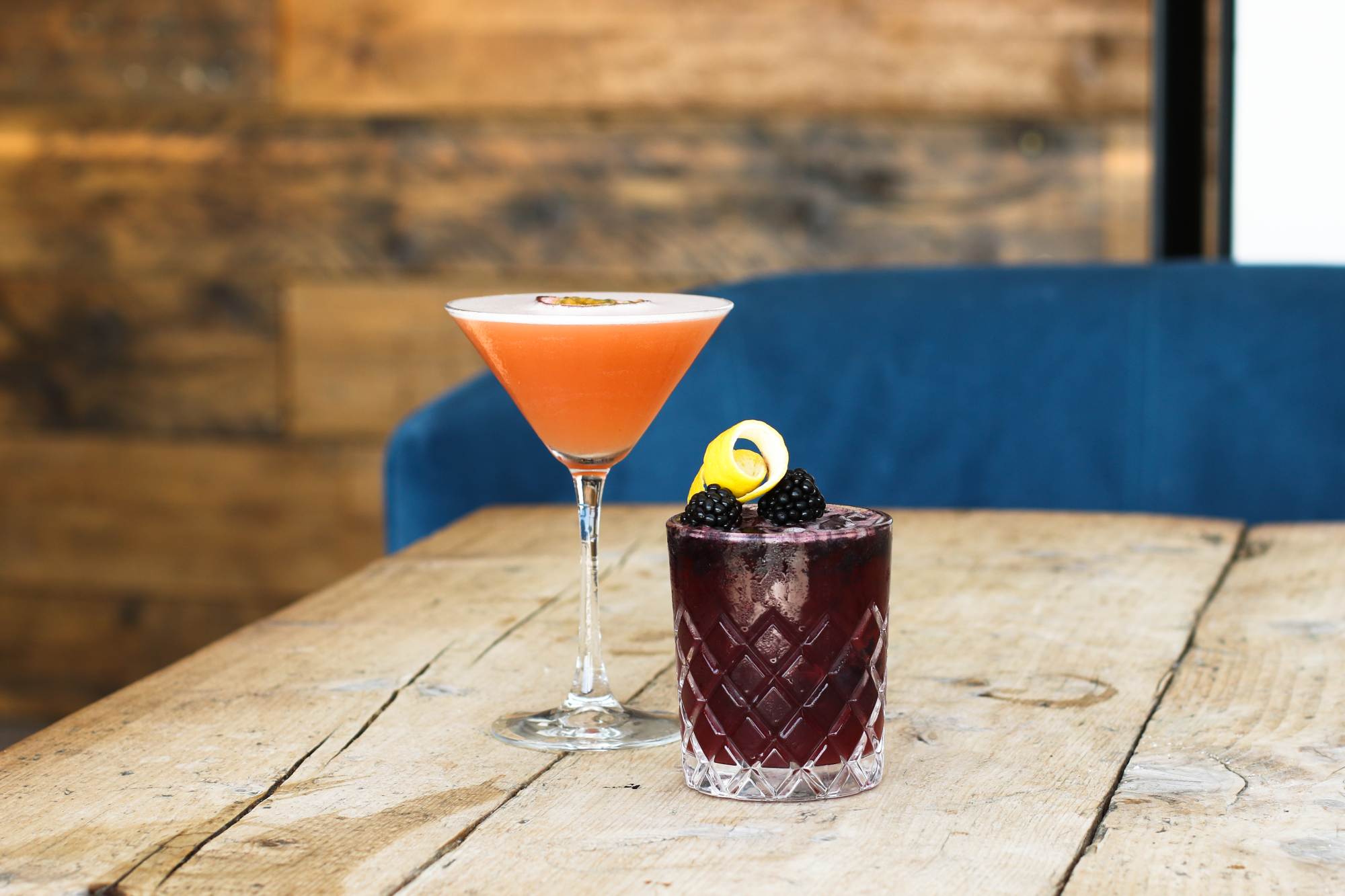 Two cocktails on a wooden table at The Cliff House bar